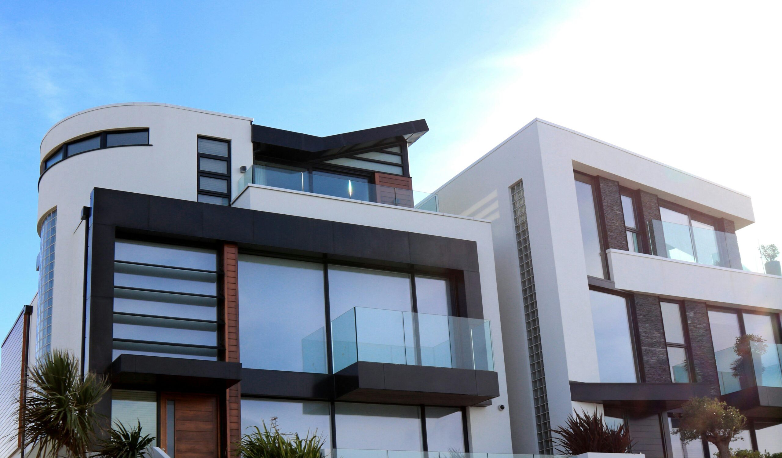 Contemporary luxury home with glass balconies in Poole, UK, showcasing modern architectural design.