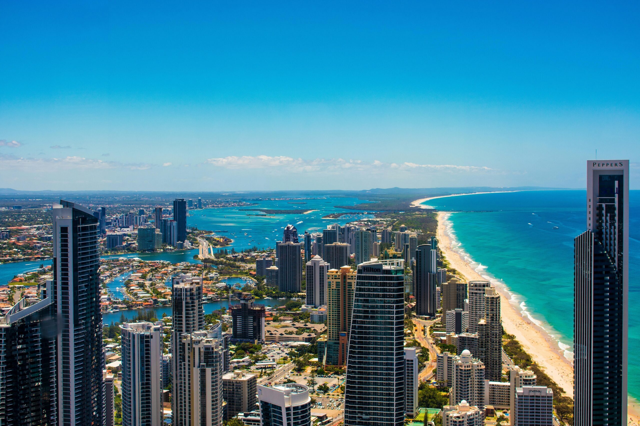 Breathtaking aerial cityscape of Gold Coast's skyscrapers, beaches, and ocean.