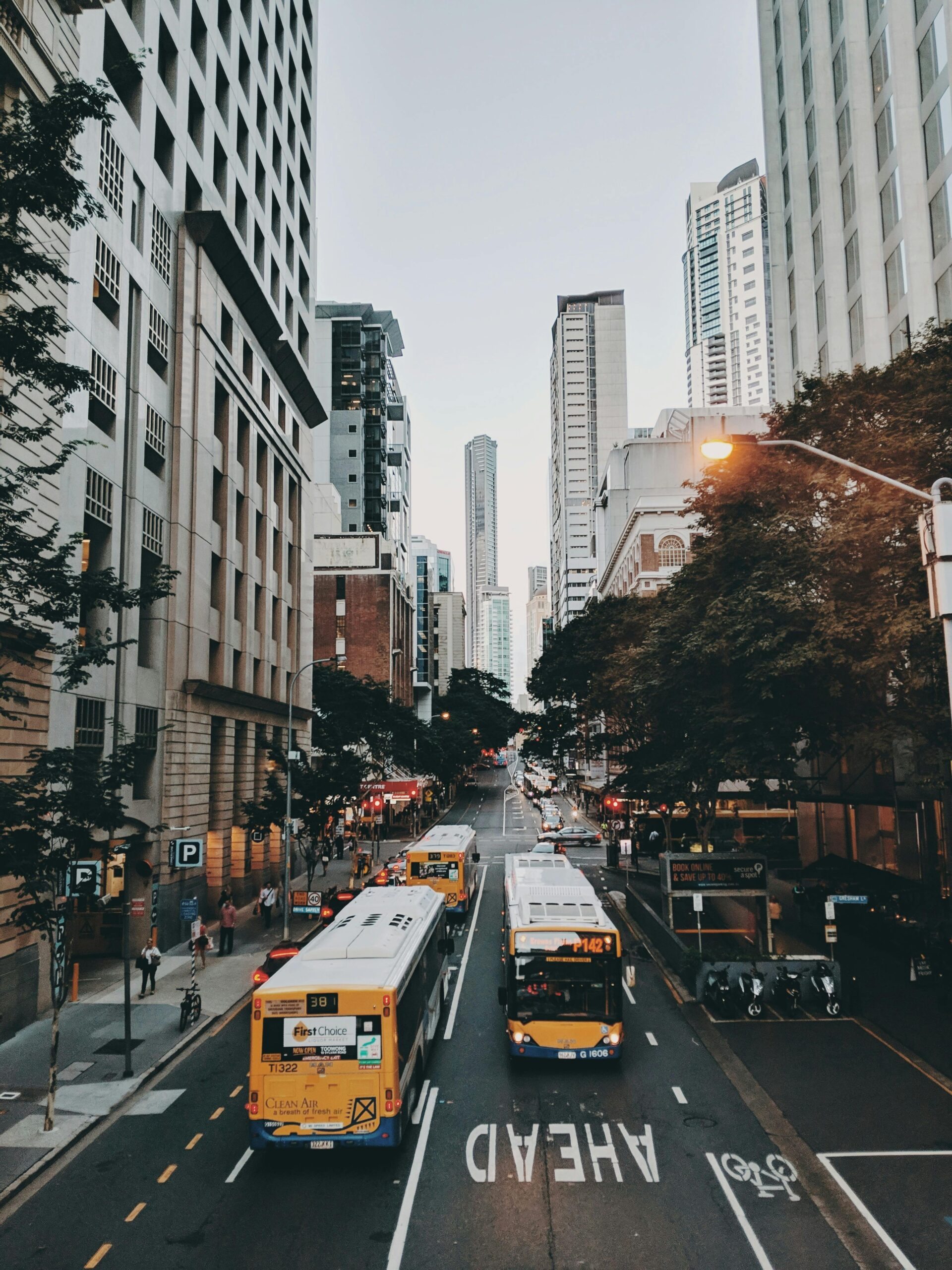 Dynamic urban scene featuring buses and pedestrians in downtown Brisbane, Australia.